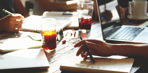 Close up of table with notebooks and a laptop